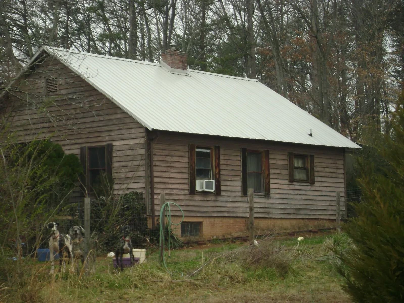 White metal roof on an old wood sided farmhouse, from a Metal Roof Installation job in Cunningham